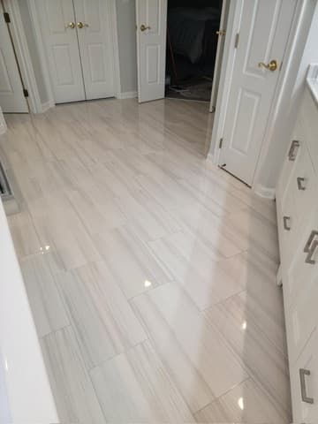 Large format tile flooring installation in bathroom