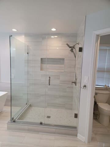 Custom tile walk-in shower with frameless glass