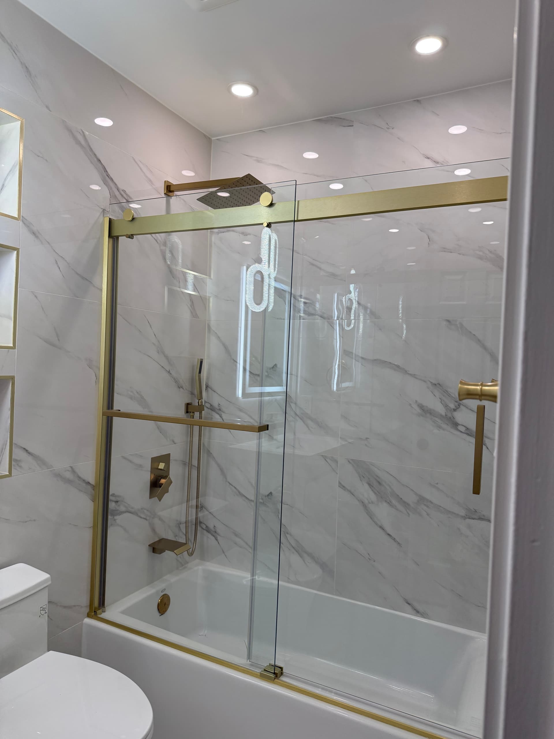 Walk-in shower with frameless glass and custom tile
