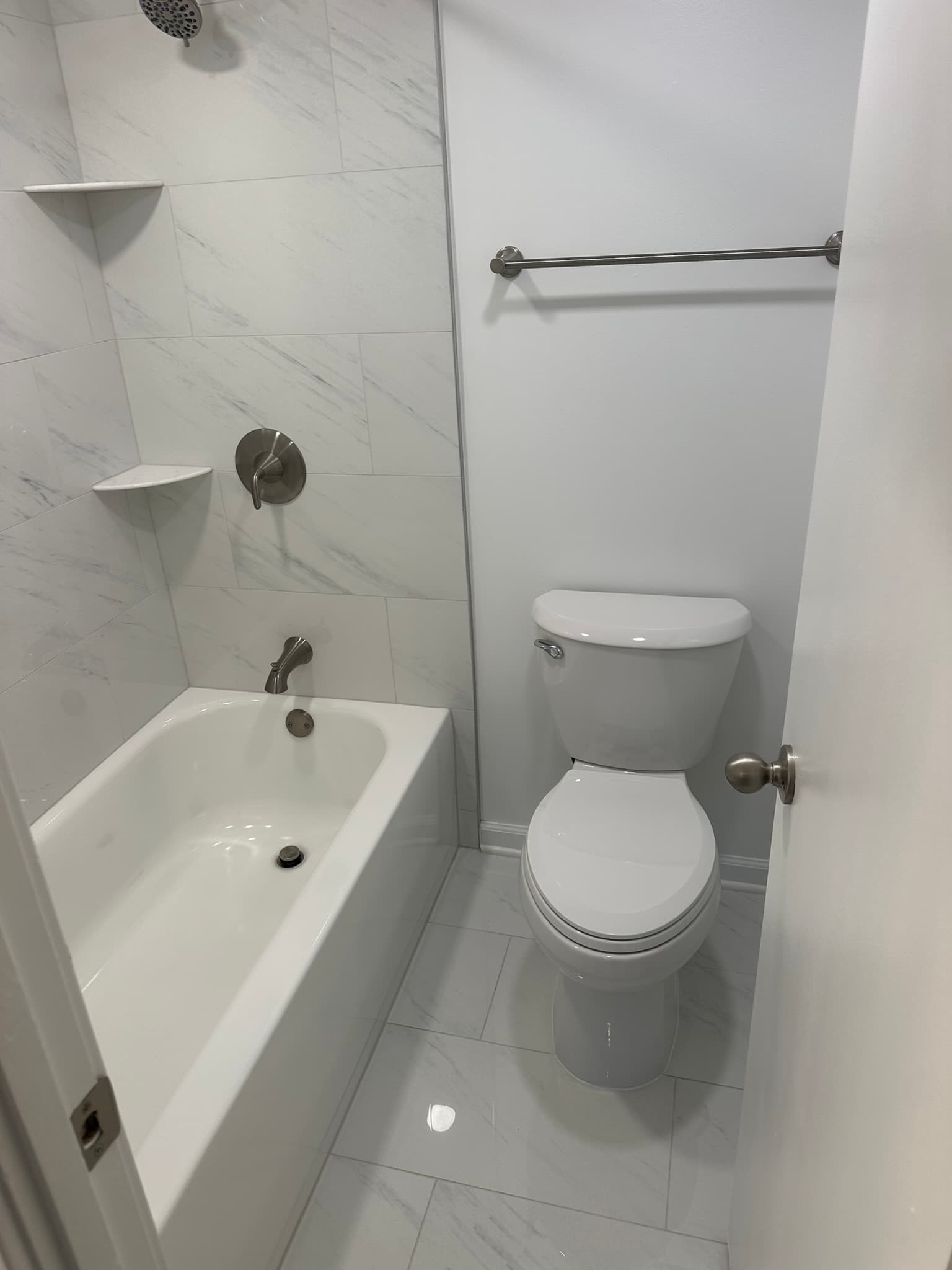 Bathroom renovation with tile and updated toilet