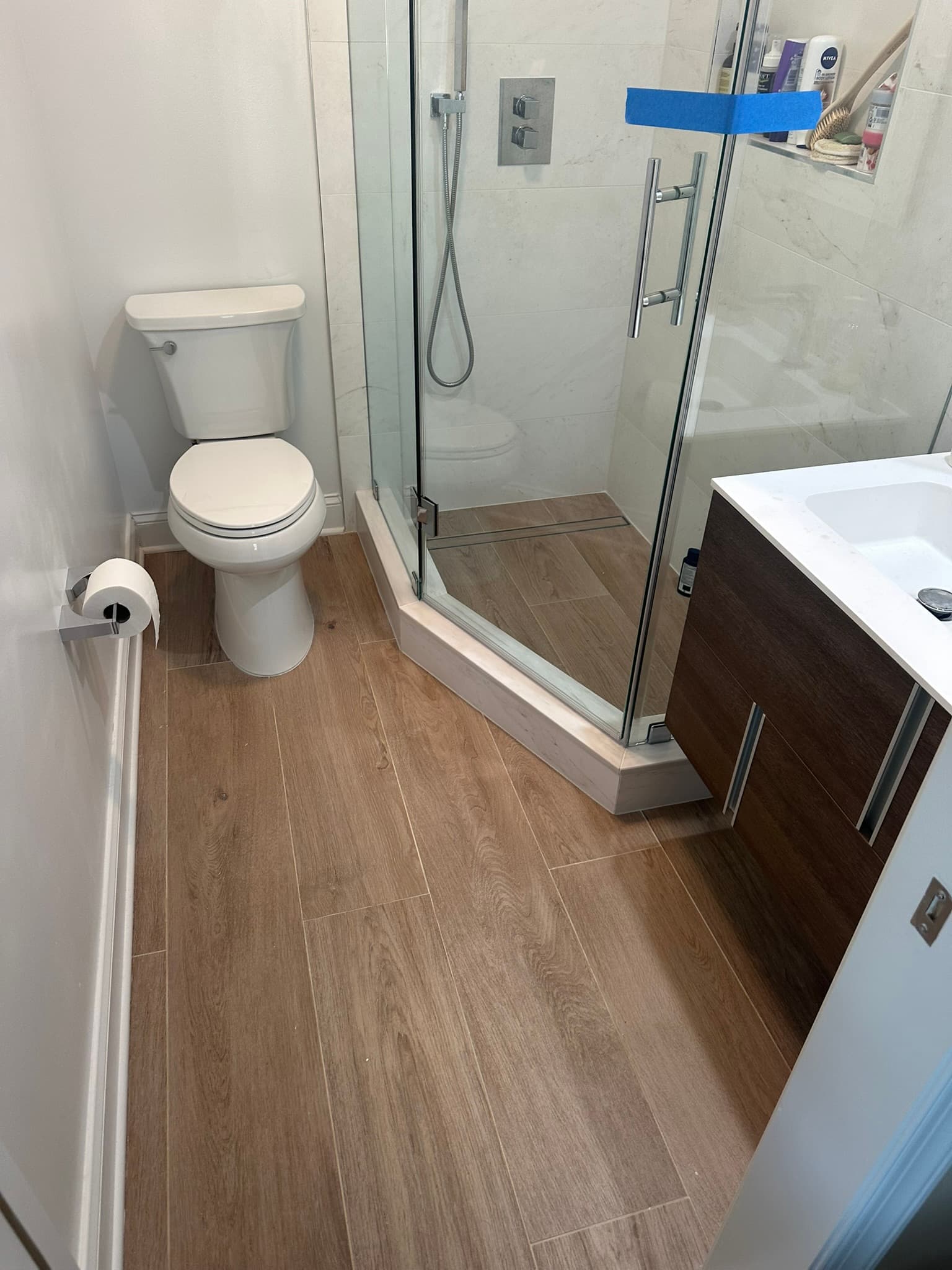 Large format tile flooring in bathroom renovation