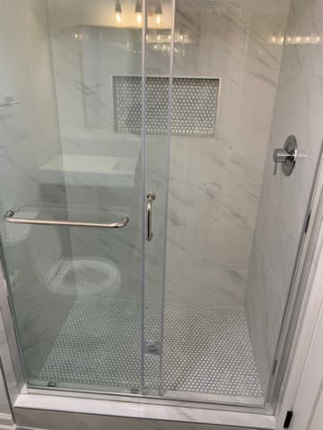 Walk-in shower with custom niche and fixtures