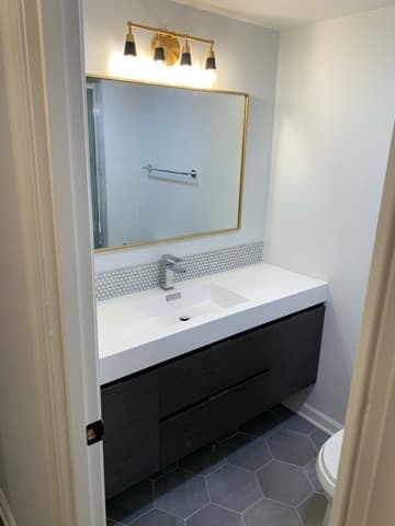 Vanity installation with custom mirror and lighting