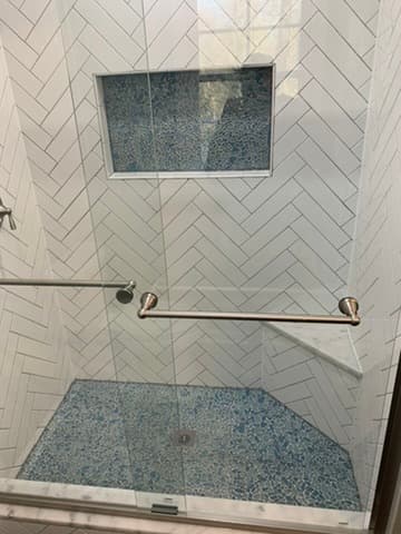 Tile shower with custom niche by Ventura Home Improvement