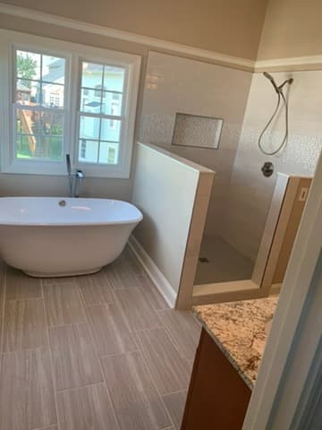 Freestanding tub with adjacent walk-in shower