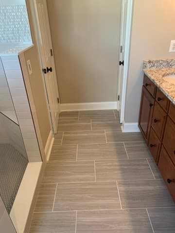 Tile flooring installation in master bathroom