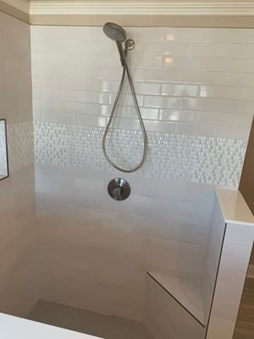 Frameless glass shower with custom tile