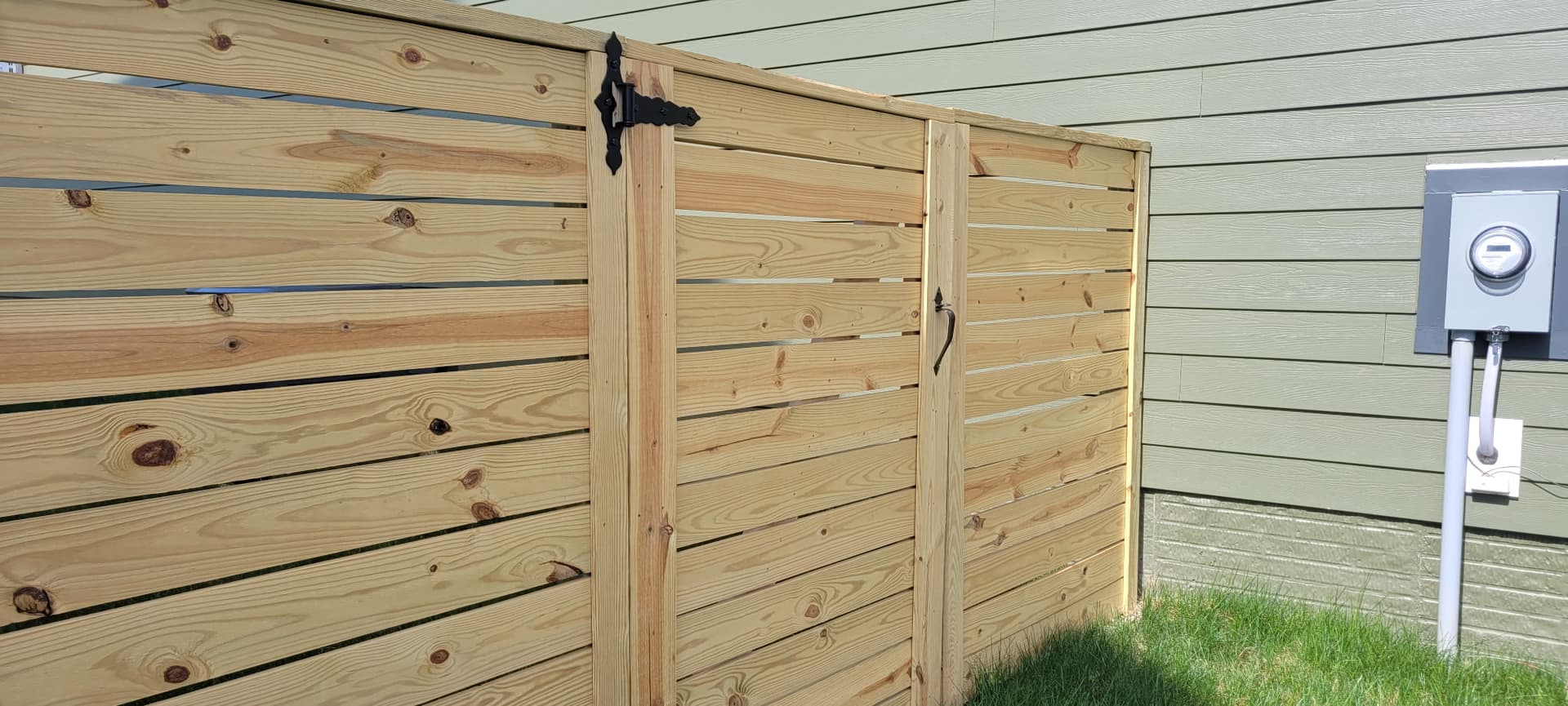 Wood fence gate with heavy-duty black hinges Northern Virginia
