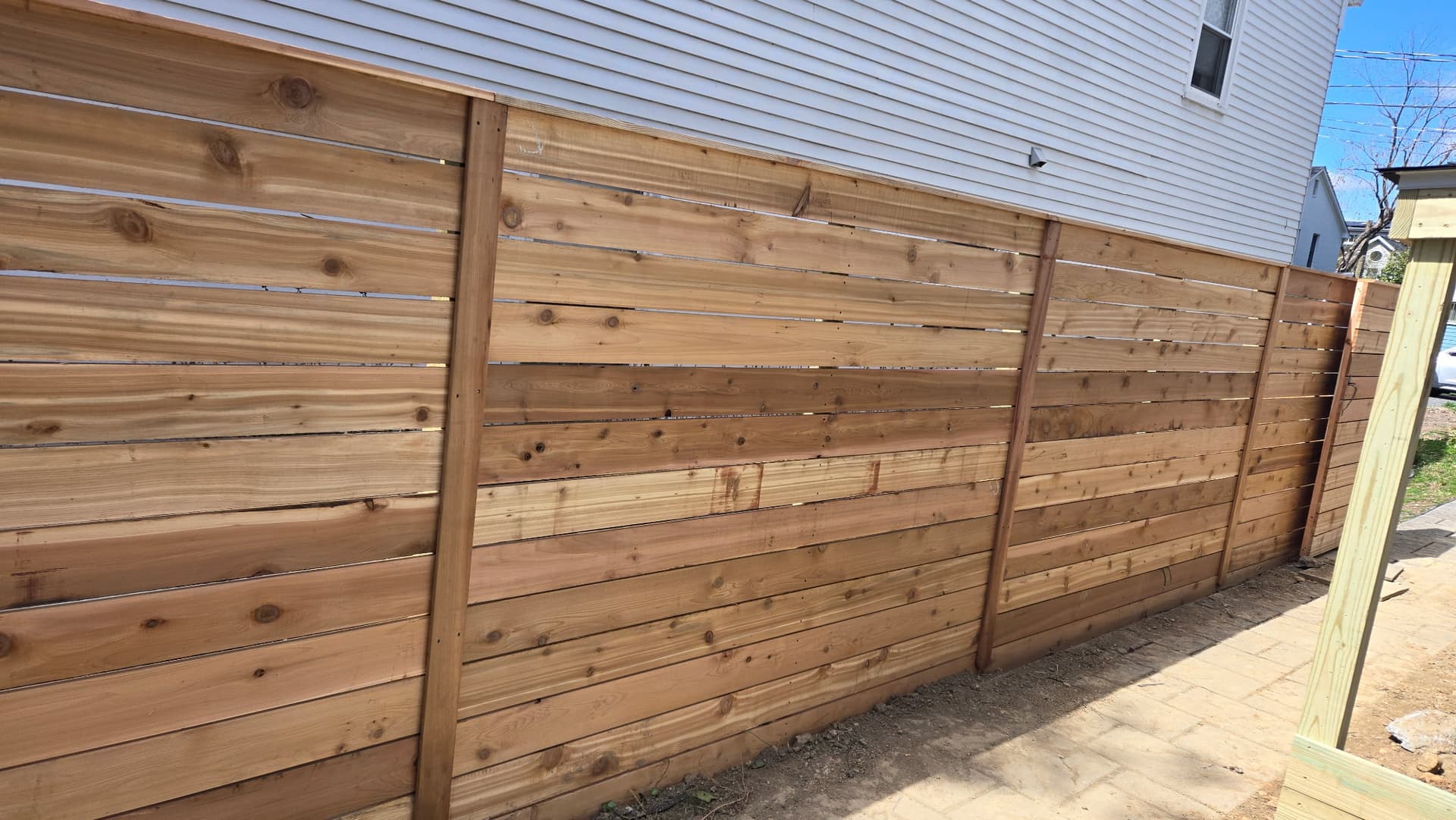 Cedar privacy fence installation with concrete pavers Northern Virginia