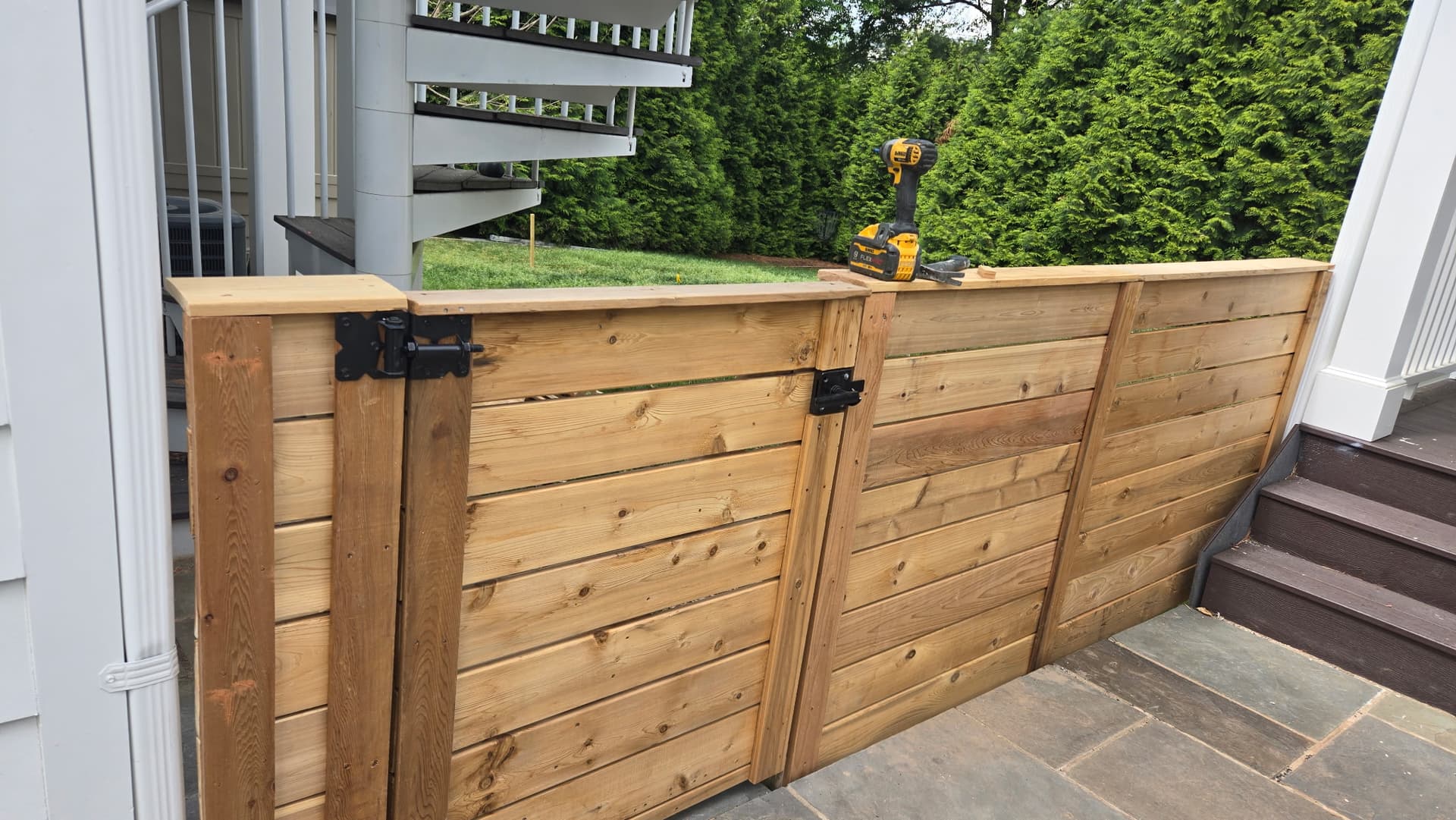 Wood fence double gate installation with black hardware by Ventura