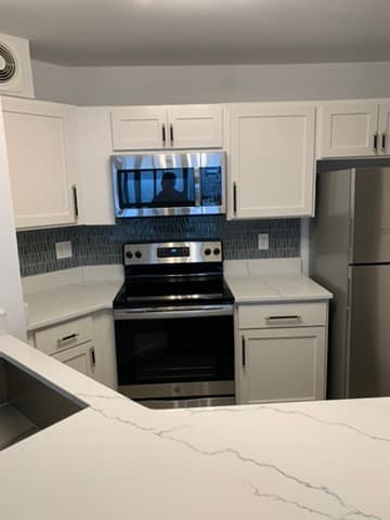 Kitchen close-up showing custom cabinet and countertop finish