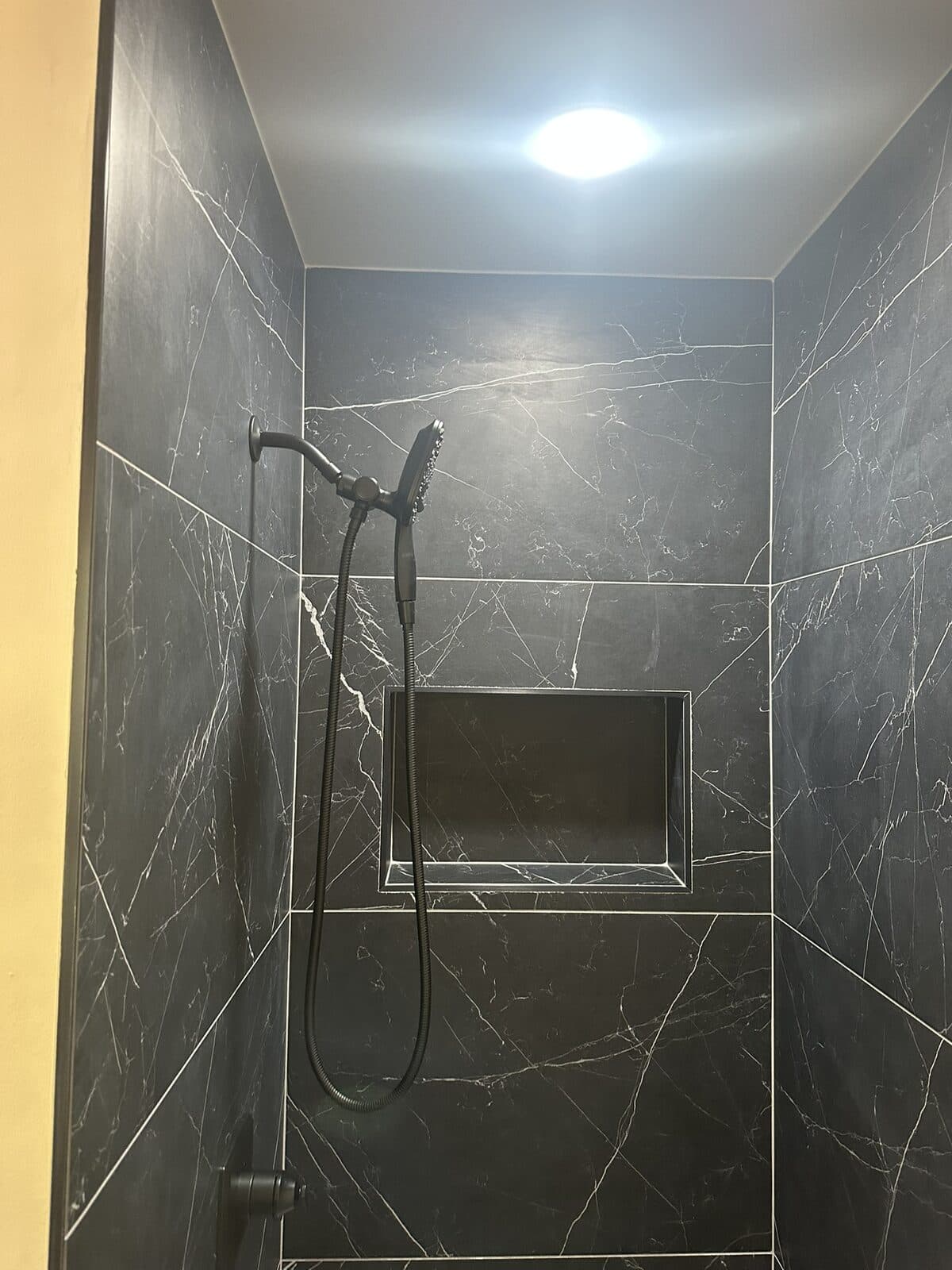 Dark tile shower renovation by Ventura Home Improvement