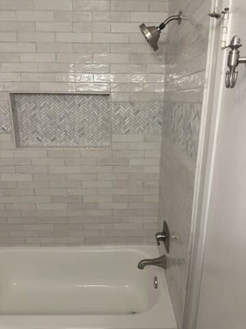 Gray tile walk-in shower by Ventura Home Improvement