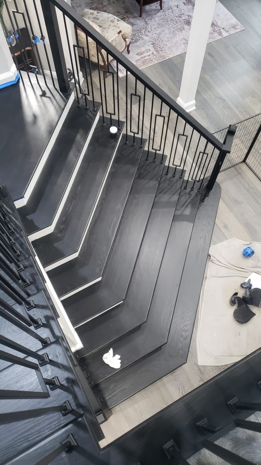 Dark staircase with custom railing by Ventura Home Improvement