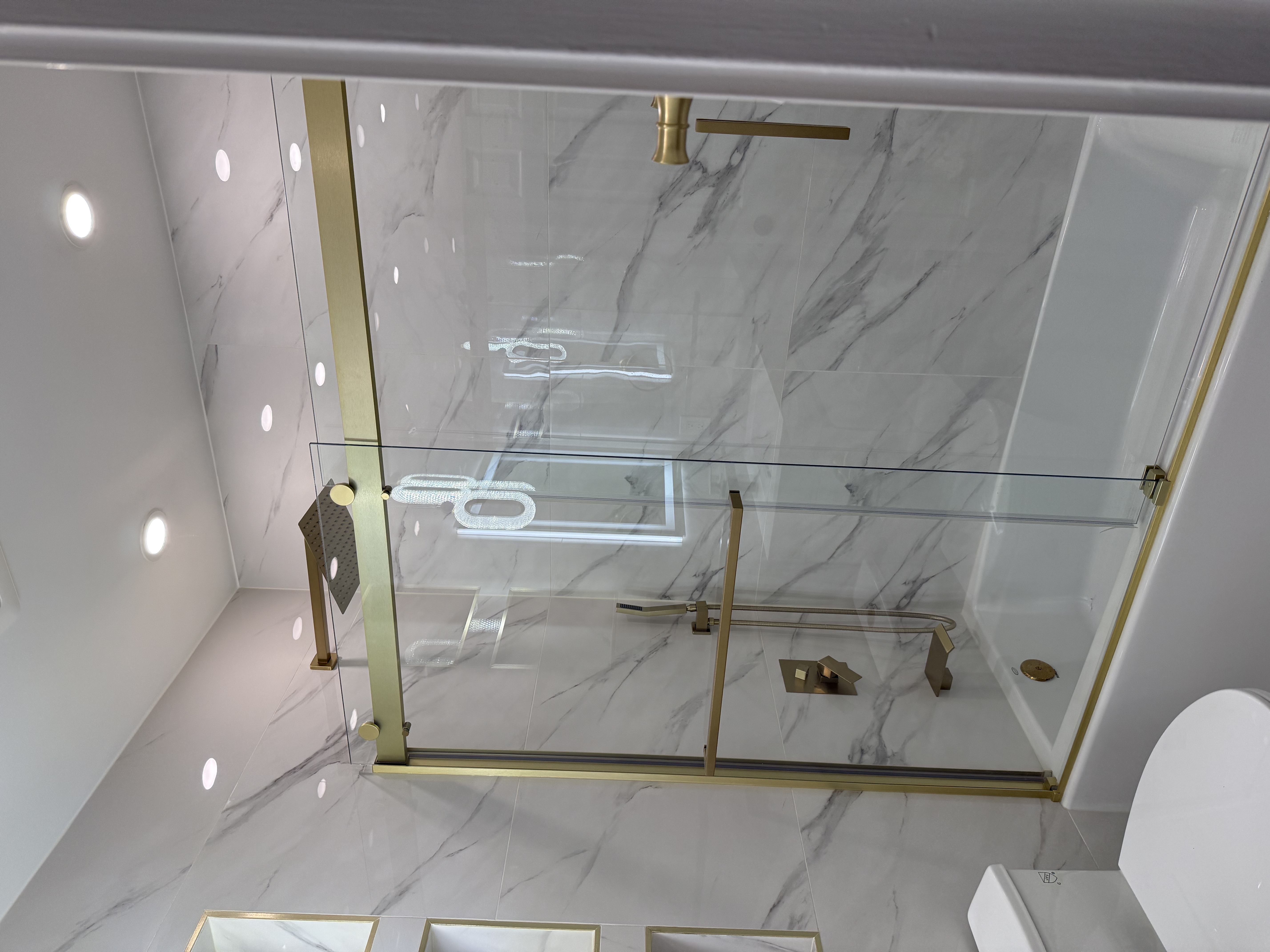 Walk-in shower with frameless glass and custom tile