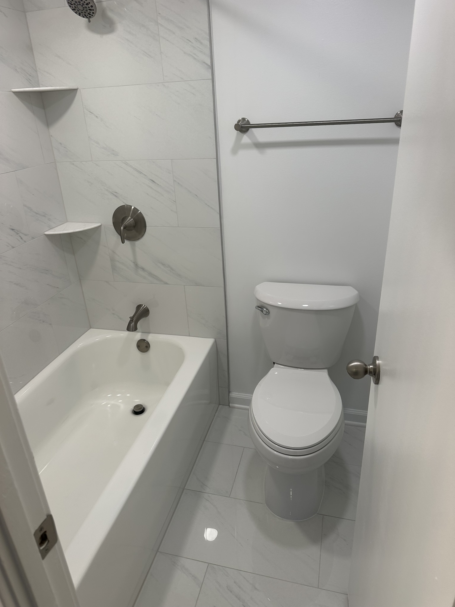 Bathroom renovation with tile and updated toilet