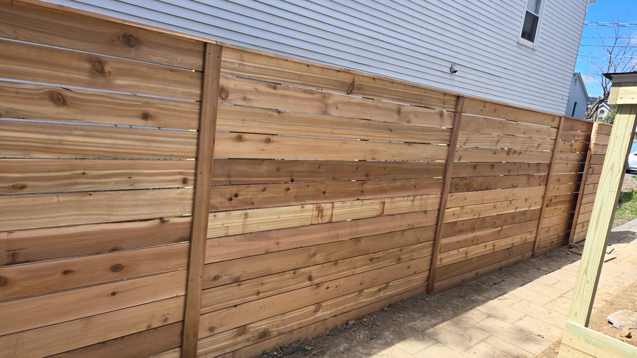 Cedar privacy fence installation with concrete pavers Northern Virginia