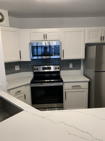 Kitchen close-up showing custom cabinet and countertop finish