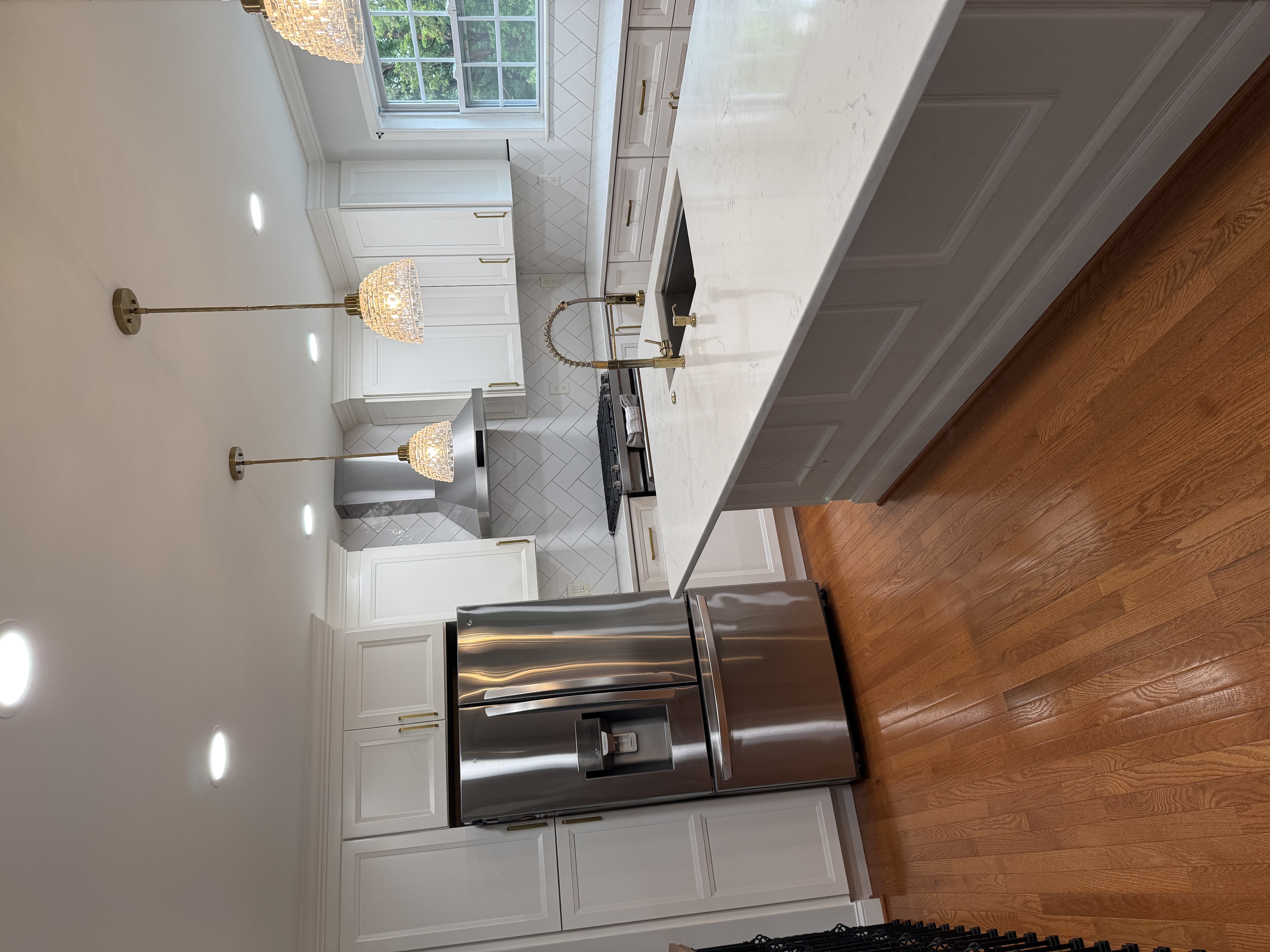 Kitchen renovation with custom cabinetry and stone countertops