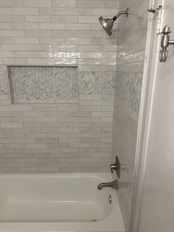 Gray tile walk-in shower by Ventura Home Improvement
